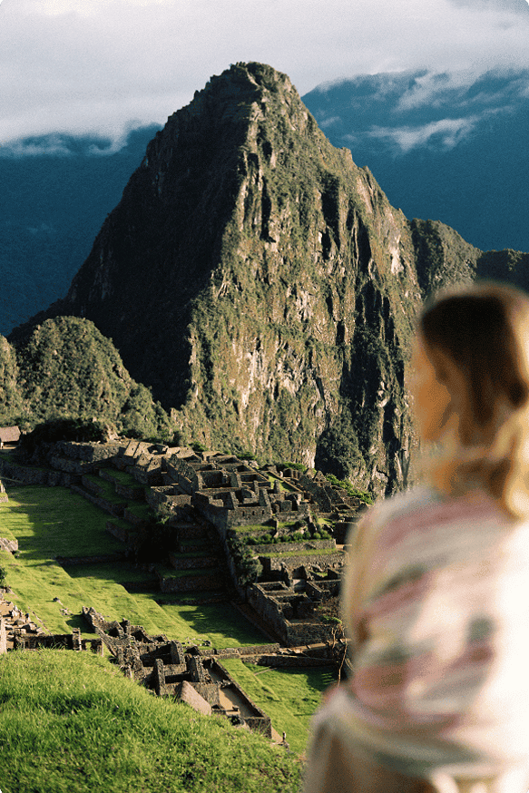 Traveler at a Machu Picchu overlook at golden hour