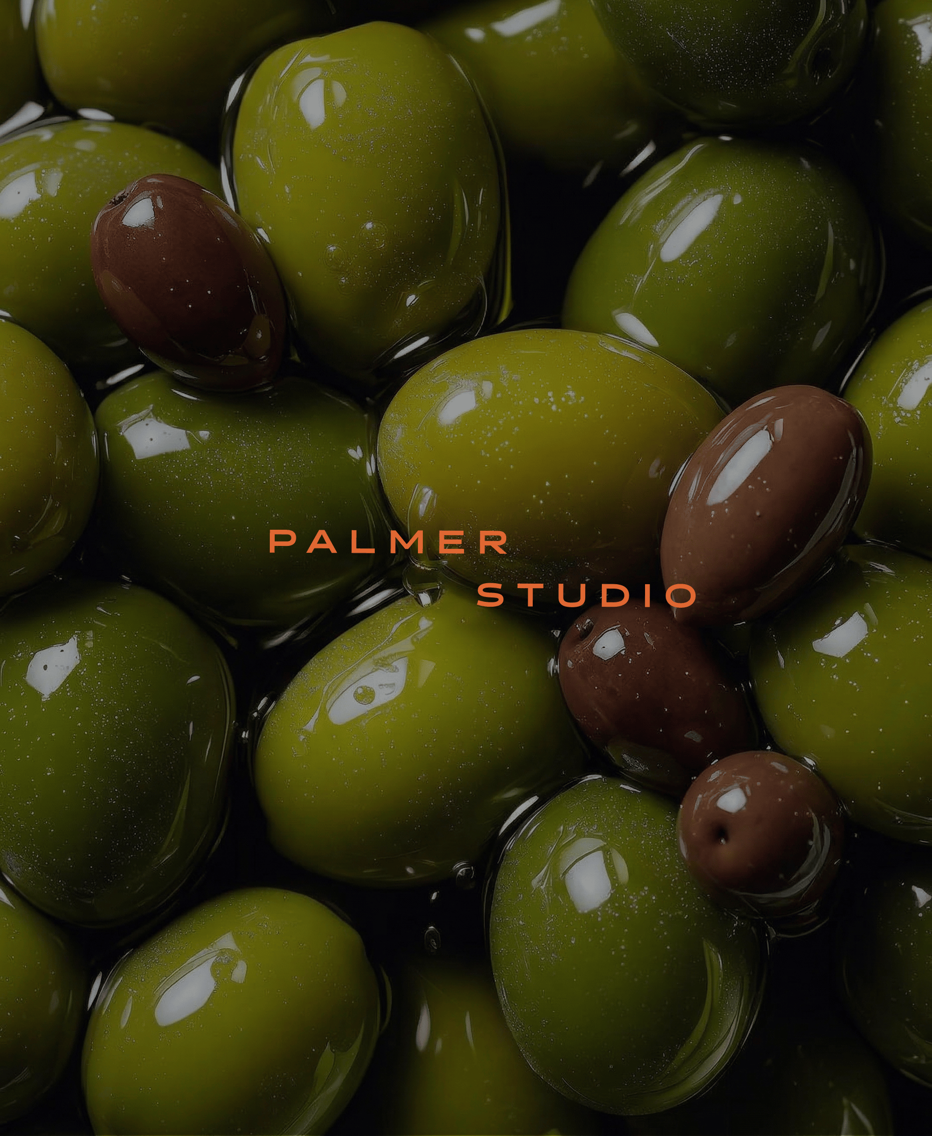 Close-up of glossy green and black olives in oil